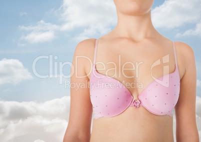 woman in pink bra with sky clouds background