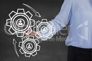 Business woman interacting with people in cogs graphics against grey background