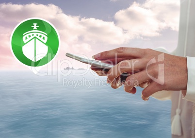 Hand holding phone with boat icon by sea