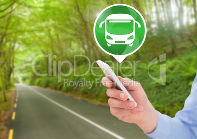 Hand holding phone with bus icon on road