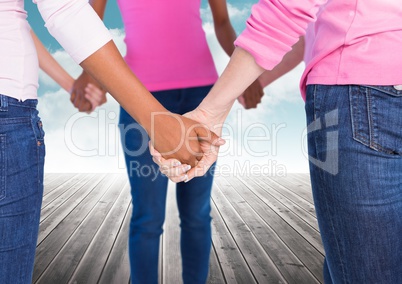 Breast cancer women  putting hands together with sky clouds background