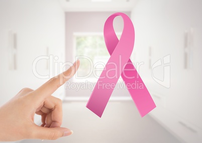 Pointing hand with pink ribbon for breast cancer awareness