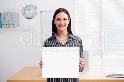 Business woman holding blank card in office