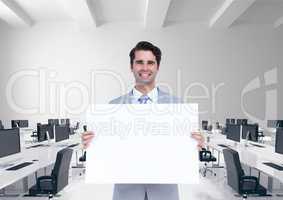 Happy business man holding blank card in office