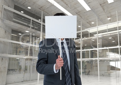 Business man holding blank card in office