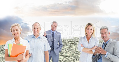 Old business people on hill of money