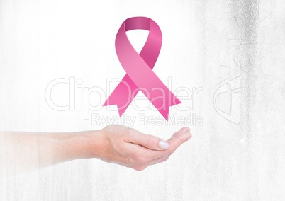 Open hand with pink ribbon for breast cancer awareness