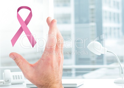 Open hand with pink ribbon for breast cancer awareness