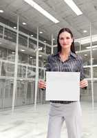 Business woman holding blank card in office