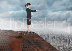 Businesswoman standing on Roof with chimney and cloudy city