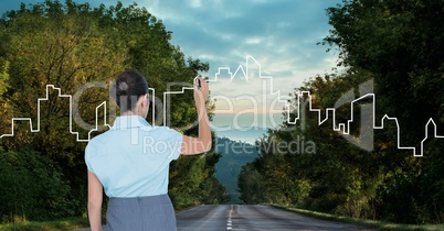 Business woman drawing a city on the road