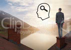 Head with magnifying glass search icon and Businessman standing on Roofs with chimney and lake mount