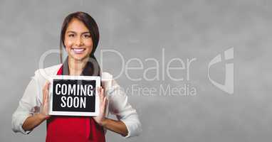 Business woman holding a tablet with coming soon text