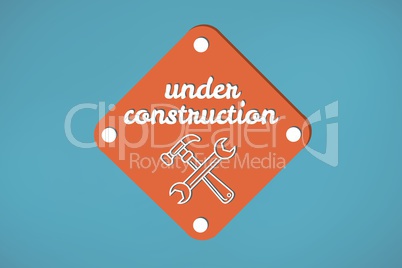 Under construction text with tools graphics in a sign against blue background