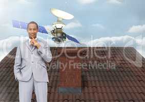 Satellite floating and Businessman standing on Roof with chimney and sky