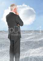 Businessman looking over sea of documents with cloud