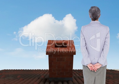 Businesswoman standing on Roof with chimney and blue sky