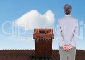 Businesswoman standing on Roof with chimney and blue sky