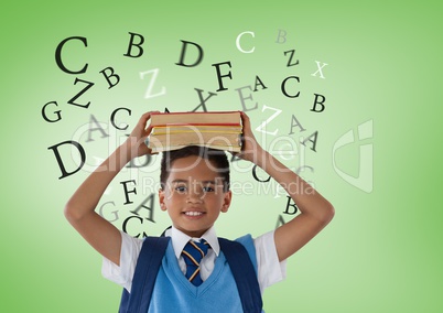 Many letters around Schoolboy holding books in front of green background