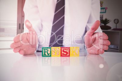 Composite image of mid section of businessman with risk text