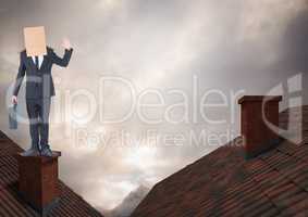 Businessman standing on Roofs with chimney and cardboard box on his head and dramatic light cloudy s