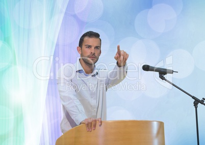 Businessman on podium speaking at conference with abstract background