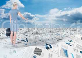 Businesswoman holding briefcase in sea of documents under sky clouds
