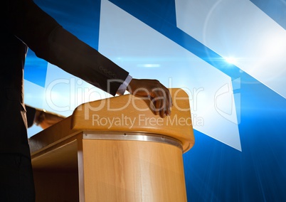 Businessman on podium speaking at conference with futuristic shapes