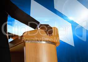 Businessman on podium speaking at conference with futuristic shapes