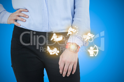 Composite image of businesswoman wearing smartwatch