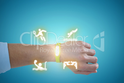 Composite image of hand of man wearing green fitness band