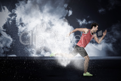 Composite image of confident male athlete running from starting blocks