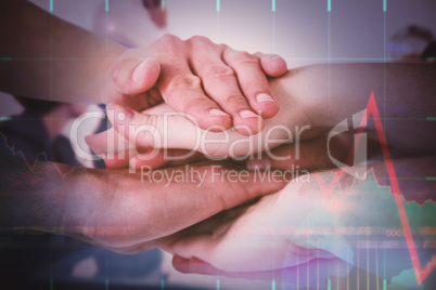 Composite image of cropped image of people forming hands stack