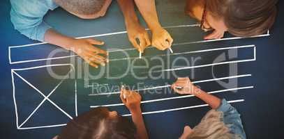 Composite image of business people writing with chalks