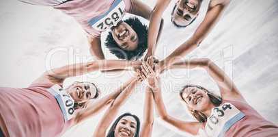 Five smiling runners supporting breast cancer marathon