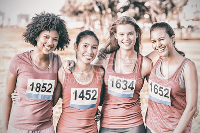 Four smiling runners supporting breast cancer marathon