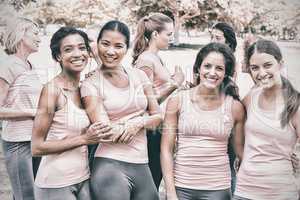 Female volunteers participating in breast cancer awareness