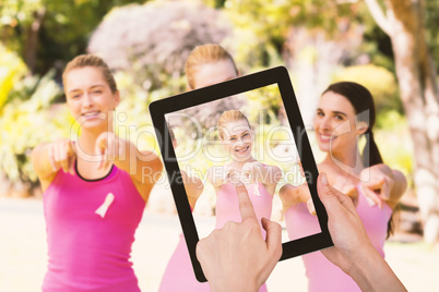 Composite image of hands touching digital tablet against white background