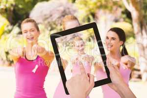 Composite image of hands touching digital tablet against white background