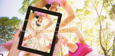 Composite image of close-up of hands holding digital tablet