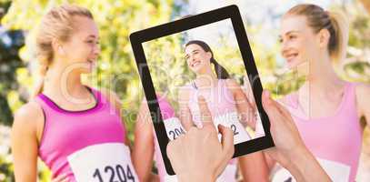 Composite image of hands touching digital tablet against white background