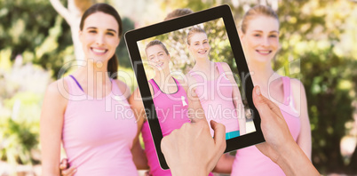 Composite image of hands touching digital tablet against white background