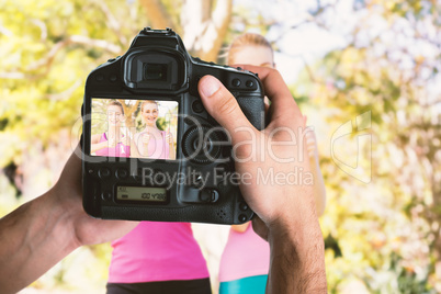 Composite image of cropped image of hands holding camera