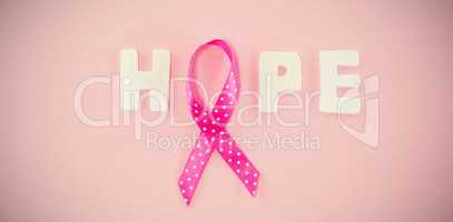 Overhead view of spotted Breast Cancer Awareness ribbon with HOPE text