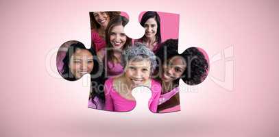 Composite image of smiling women in pink outfits posing for breast cancer awareness