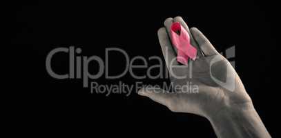 Cropped image of hand holding pink ribbon