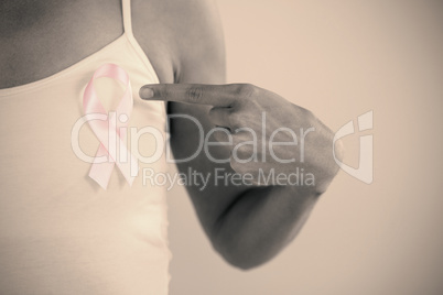 Mid section of woman pointing at ribbon