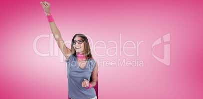 Composite image of smiling woman in superhero costume with arm raised