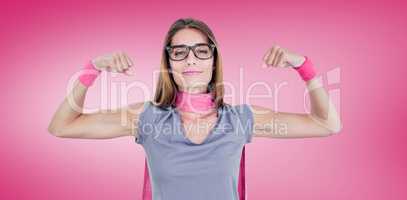 Composite image of portrait of smiling woman in superhero costume while flexing muscles