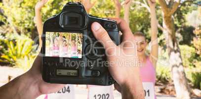 Composite image of cropped image of hands holding camera